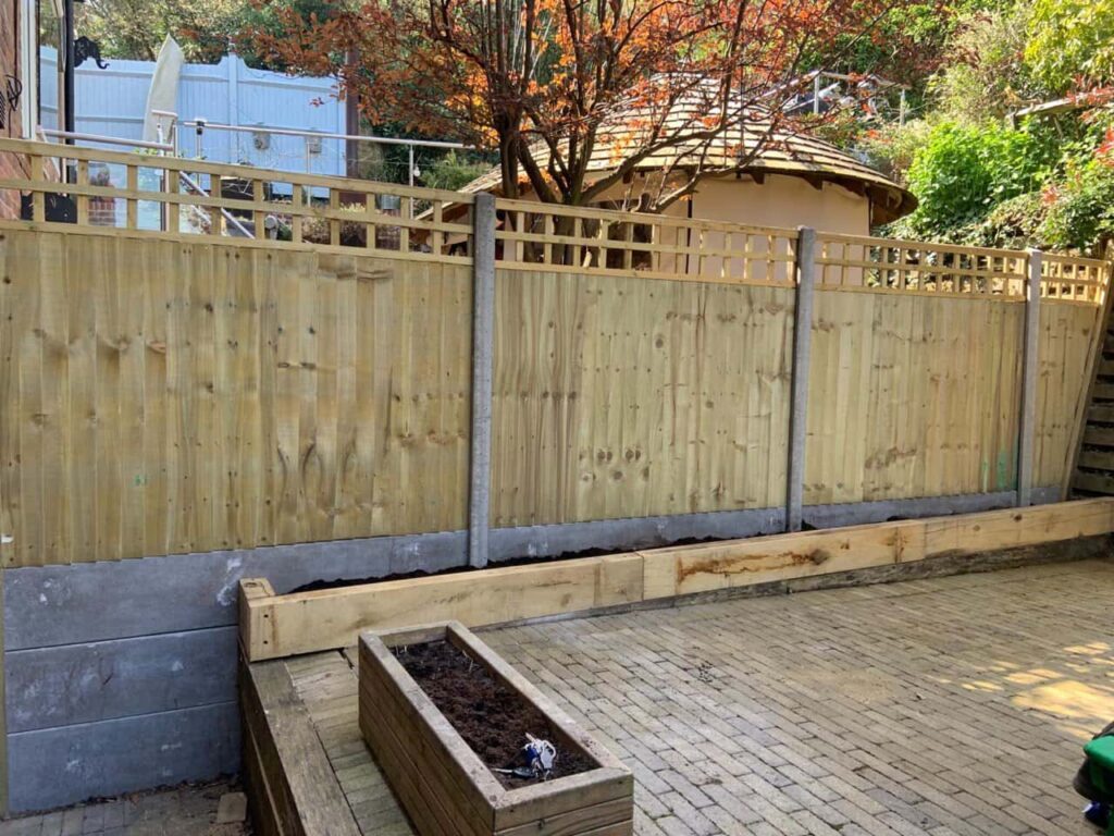 This is a photo of a trellis fence, constructed with concrete posts and gravel boards. The works have been carried out in a residential property by Fast Fix Fencing.