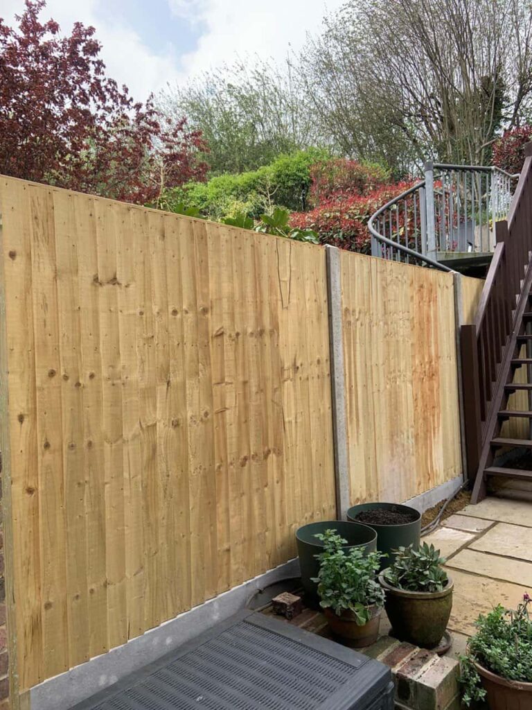 This is a photo of fence panels installed in a residential garden using concrete posts and gravel boards. Installed by Fast Fix Fencing