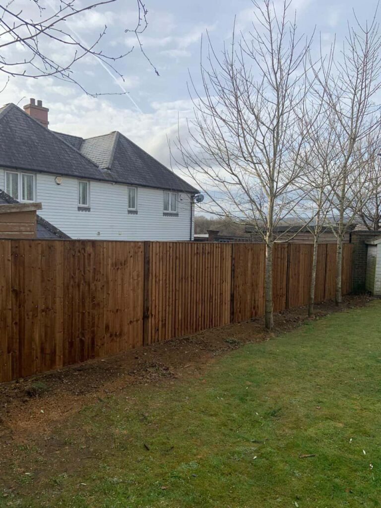 This is a photo of feather edge fencing installed in a residential properties garden by Fast Fix Fencing