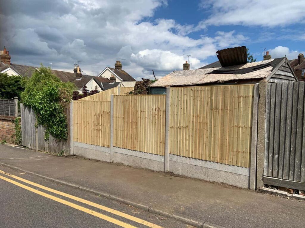 This is a photo of fence panels installed around the edge of a garden. Using concrete posts and concrete gravel boards. Works carried out by Fast Fix Fencing