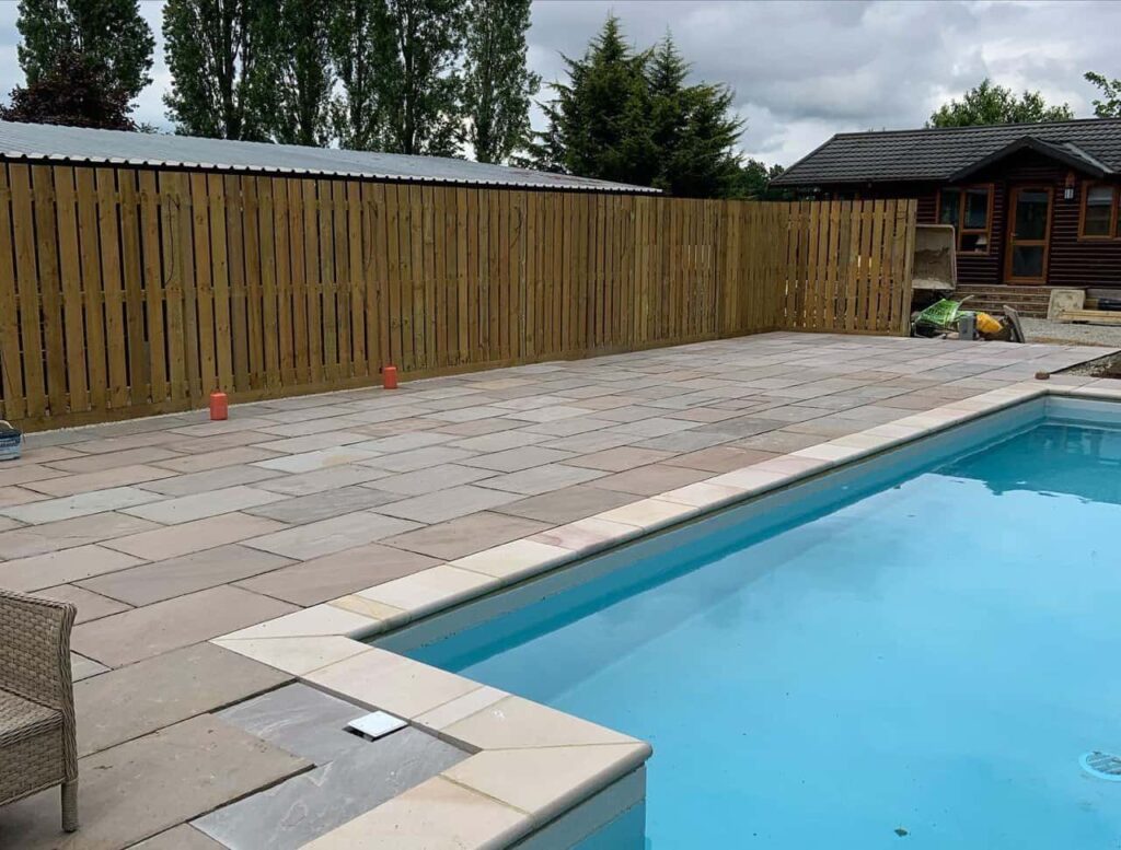 This is a photo of Bespoke custom fencing installed around a swimming pool by Fast Fix Fencing.