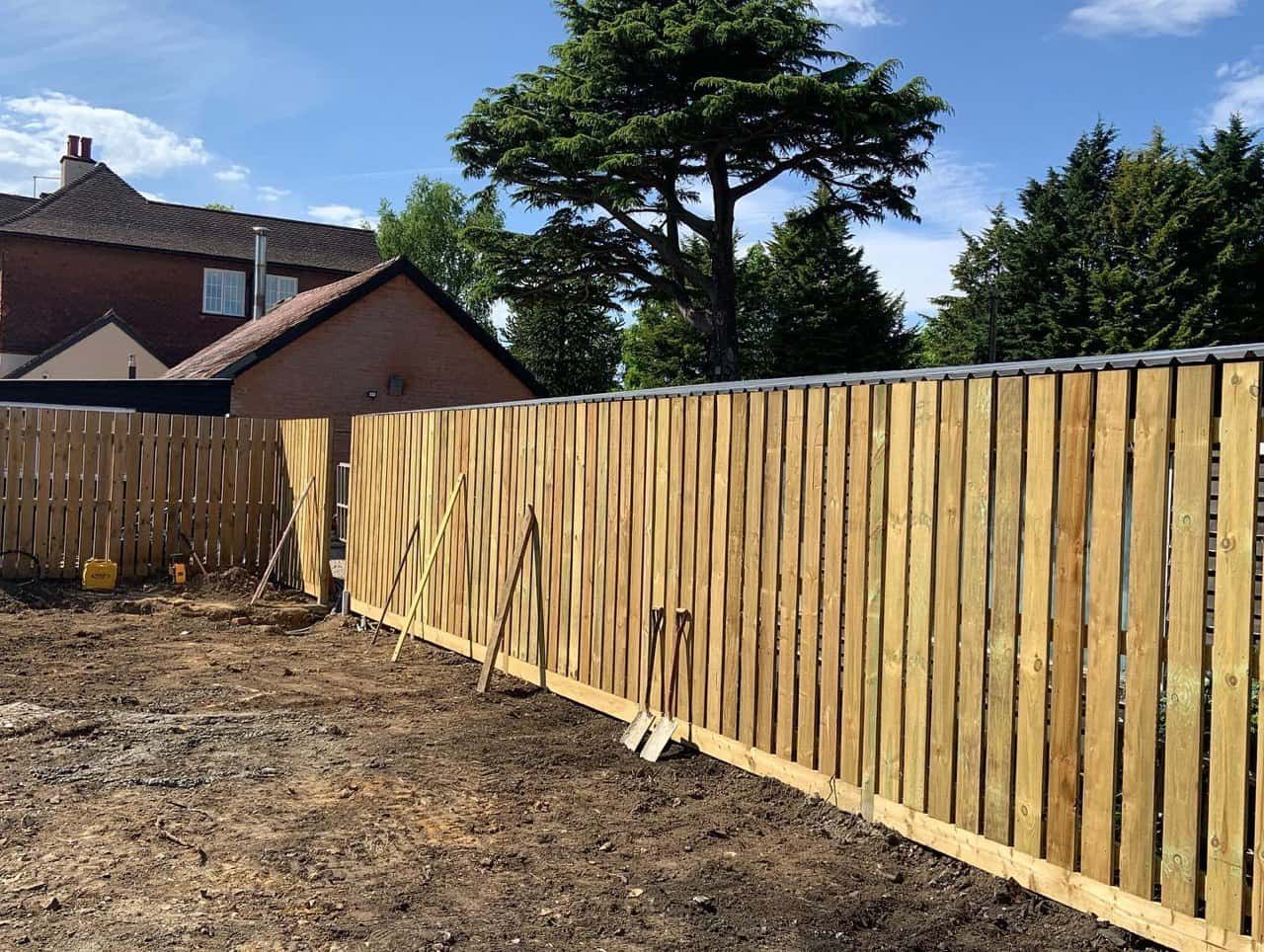 This is a photo of a custom designed fence being installed around a swimming pool.