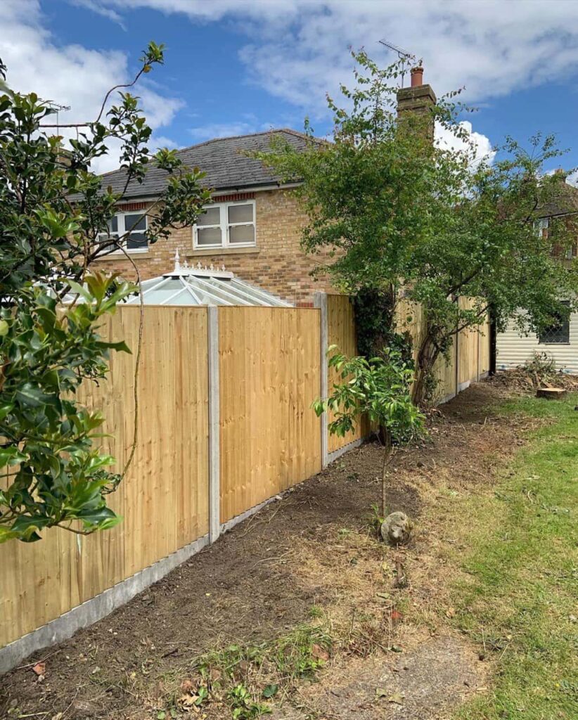 This is a photo of fence panels installed in a residential garden using concrete posts and gravel boards. Installed by Fast Fix Fencing