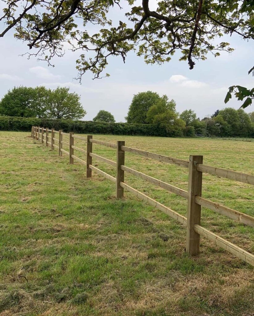 This is a photo of a post and rail fence installed in a field by Fast Fix Fencing