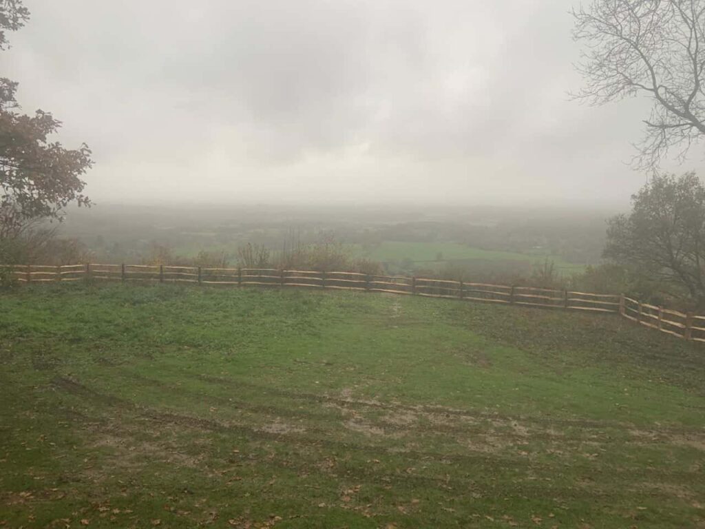 This is a photo of a Post and Rail fence installed around the edge of a field by Fast Fix Fencing