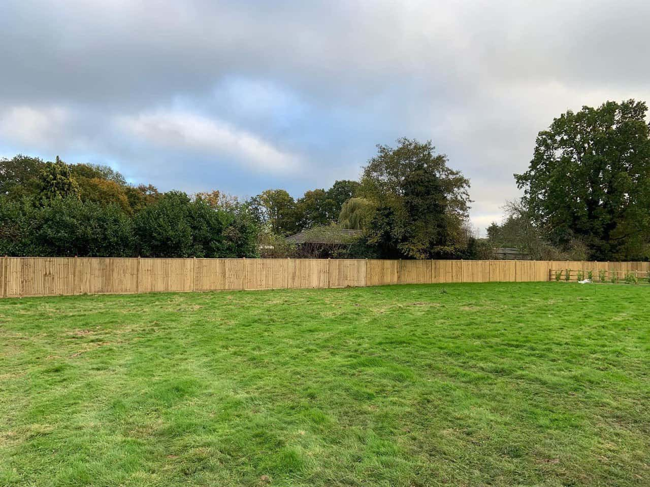 This is a photo of a feather edge fence that has been installed around the perimeter of a field.  