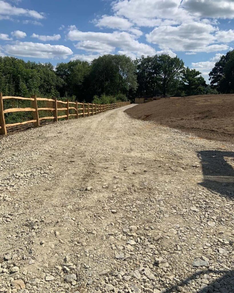 This is a photo of post and rail fencing installed along the edge of an agricultural type 1 laid track. Installed by Fast Fix Fencing